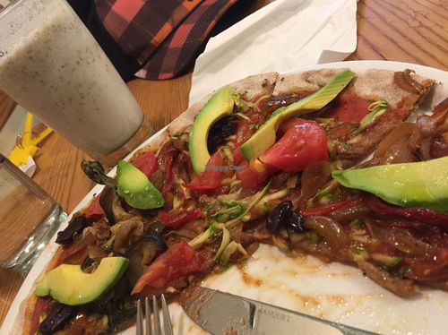 Vibrant vegan pizza and coconut milkshake at Avocado in Athens
