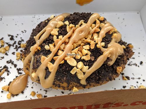 Donut with pumpkin frosting (seasonal), Oreos, peanuts, peanut butter drizzle at Duck Donuts in Irvine