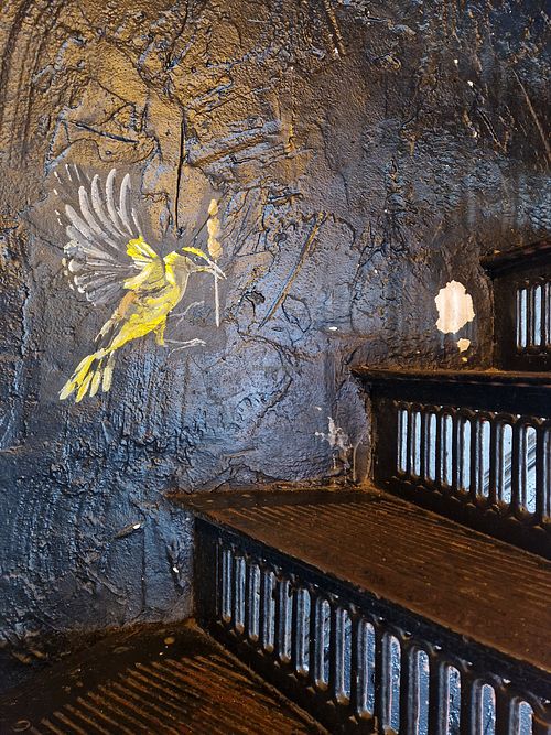 Steep stairs had pretty art on them (I imagine those are pieces of tofu the bird is carrying). at Satay in Antwerpen