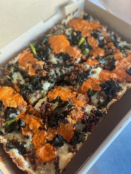 Detroit style vegan pizza with sausage, kale, and vodka sauce  at TNT Pizza in San Diego