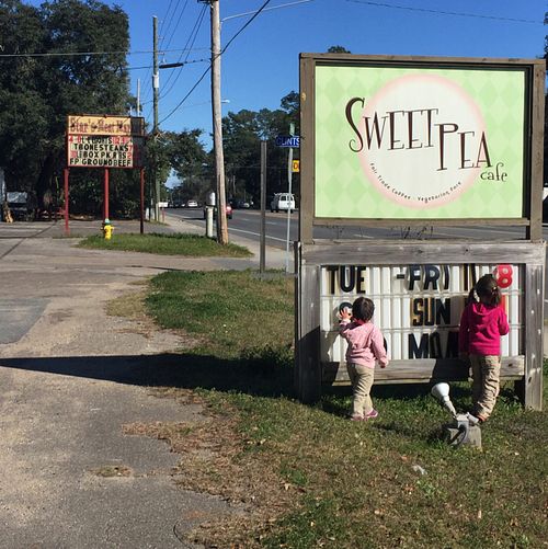 always choosing vegan over meat (see meat market sign in the background)  at Sweet Pea Cafe in Tallahassee