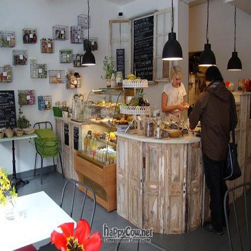 Interior, the bar is built from recycled doors from a nuns monestry. Recycled church benches and other antiquities create an welcoming atmosphere  at Raw Food House in Malmo