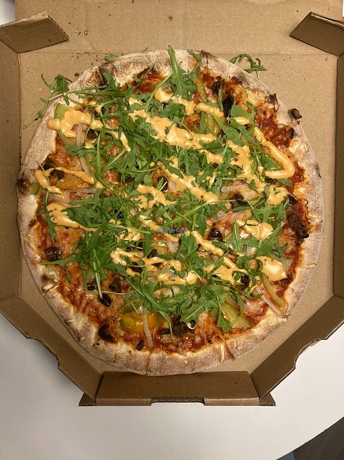 Grænkerinn vegan pizza (Sauce, vegan cheese, garlic, dates, onion,
 green paprika, rugula, spicy mayo, black pepper) at Reykjavik Pizzeria in Reykjavik