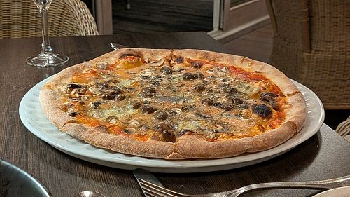 Pizza with mealty vegan cheese at Il Basilico in Zurich
