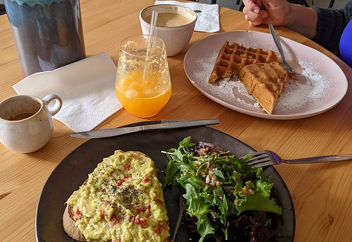 Avocado toast with seeds and some greens, waffles with peanut butter, oat milk latte 😀👍 at The Coffee Studio in Lagos