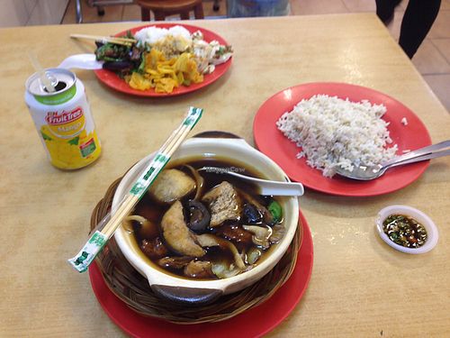 Rice and buffet dishes in background, buk kut teh with brown rice in foreground  at Sweet Veggie in Kuala Lumpur