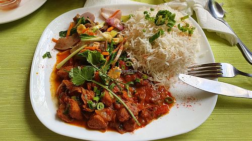 Crispies in gravy with sauteed veggies and rice at Mo Filaos in Baie Du Cap