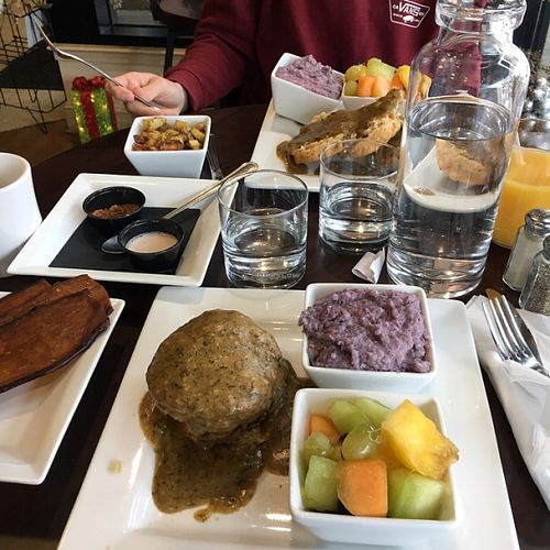 Brunch: eggplant bacon, tempeh sausage, biscuits and gravy, blue grits, roasted potatoes, fruit at Good Life Cafe in Columbia