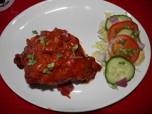 Jacket potato with vegetable chilli and salad garnish at Hillside Shire Horse Sanctuary Cafe in West Runton