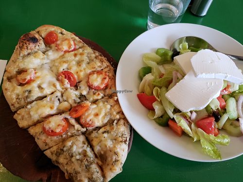 Rosemary pesto, cherry tomato and mozzarella focaccia, with a side Greek salad at Bayit 77 in Amirim