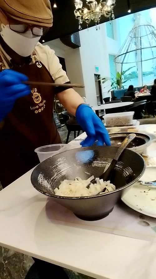 Tam prepares my "takeaway" right at the table at Love Veggie Macau in Macau