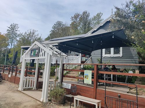 Entrance of Myrtle and Stone cafe, with the white fenced veranda at Myrtle and Stone in Wollombi