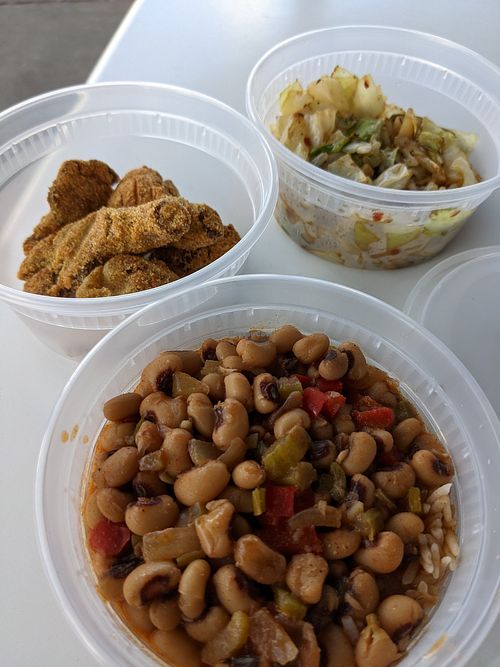 Lightly battered fried mushrooms, spicy cabbage, with black eyed peas and rice. at the hive vegan eatery in Houston