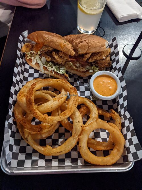 Oyster mushroom po'boy with Cajun spiced onion rings at the hive vegan eatery in Houston