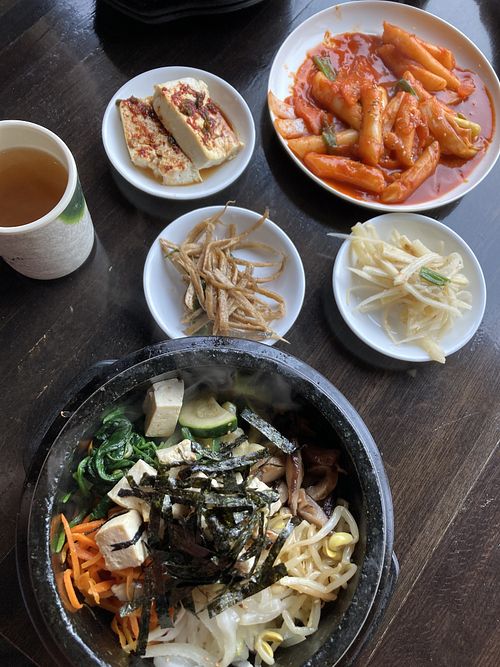 Hot stone bibimbap and ddeokbokki with complimentary side dishes and tea   at Gangnam Style Korean Kitchen in Syracuse