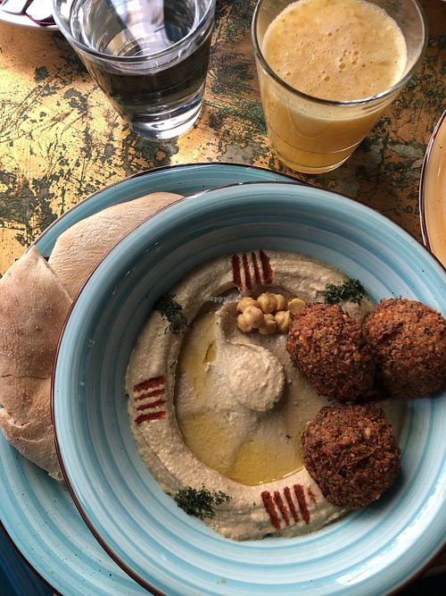 Hummus and falafels, fresh orange juice  at KAFKA Hummus Café  in Prague