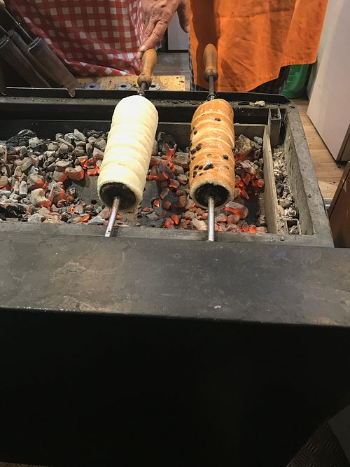 Vegan chimney roasting over coals - one with choc chips and the other with sugar and cinnamon cooking away. at Vegan Garden Budapest in Budapest