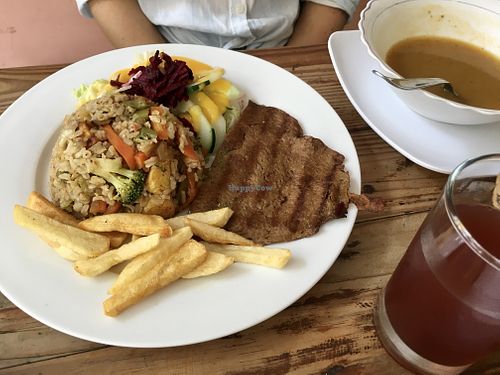 Paella w broccoli & meaty chunks, salad w creamy citrus dressing, quinoa meat w hammy flavors, carrot soup, hibiscus tea = happily stuffed! at Govinda's in Santa Marta