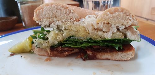 Inside the bagel, cashew cream, sauerkraut, coconut basin, rocket.. at New Day Rising in Brunswick East
