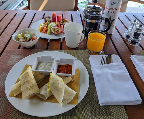 Vegan breakfast dosa, fruit plate, juice, coffee with almond milk at Ayada Maldives in Maguhdhuvaa Island