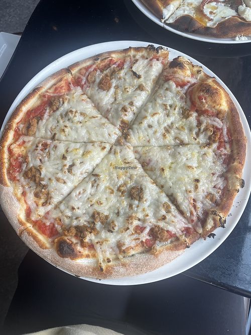 Red marinara pizza with added vegan cheese and vegan sausage   at MidiCi in Monterey