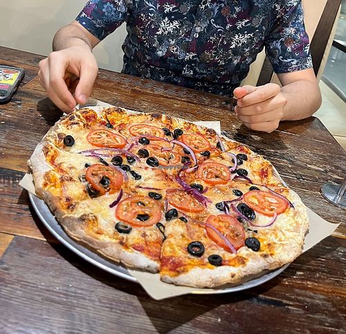 Vegan cheese, tomato, red onion and black olive pizza  at Your Pie in Houston