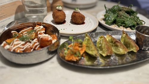 Mildred's sampler second course. va'atar padron peppers, pan-fried dumplings, ketchup harissa potato, crunchy coated risotto balls   at Mildreds - Covent Garden in London