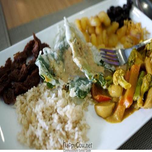 Items from the vegan buffet - vegetable curry, brown rice, crispy kangkong with sesame dip, mock adobo flakes with atsara. at Quantum Cafe in Metro Manila
