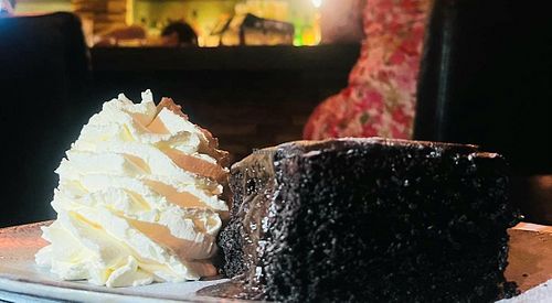 Chocolate cake and whipped cream at Alpaca Bar in Tel Aviv