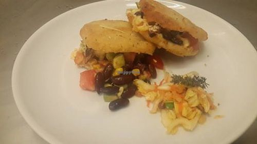 Arepas(colombian corn bread) with red beans, corn, tomato, cheese and avocado. Salad is carrot raisins and chinese cabbage. at Govinda's Restaurant in Septon