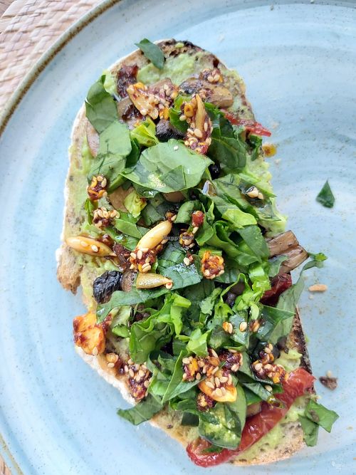 Avocado toast with dried tomatoes, mushrooms and spinach. at Trastévere in Valle De Bravo