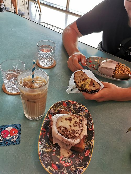 Iced latte, hot Dog, cinnamon roll at Bury Me Standing in Cairns
