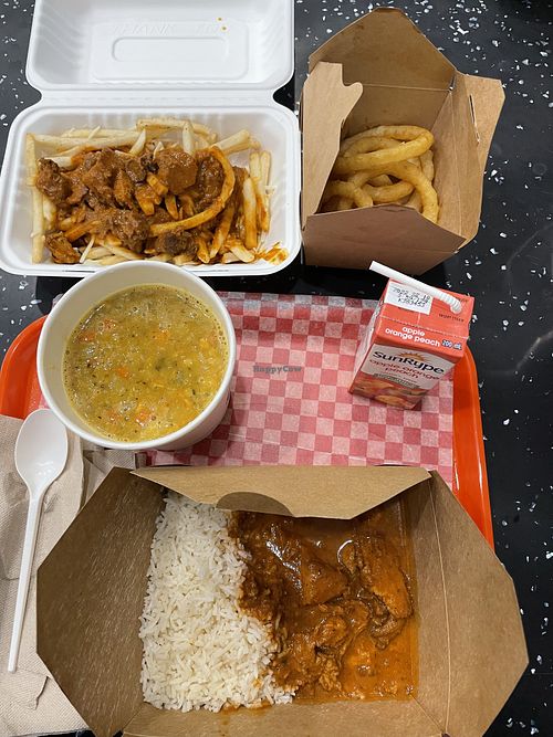 Butter chicken on fries, onion rings, lentil stew, juice box and butter chicken on rice   at Vegango in Edmonton