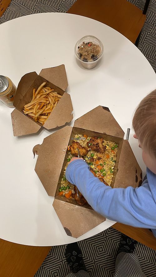 The orange cauliflower with tofu fried rice in the main box. Peanut butter parfait in the small cup    at Native Foods - Lakeview in Chicago
