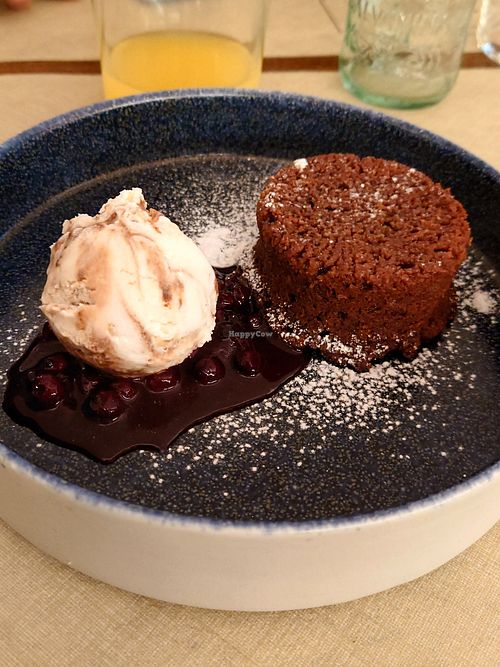 Vegan brownie with forest fruits jam/sauce and vegan ice cream at Paninothek in Innsbruck