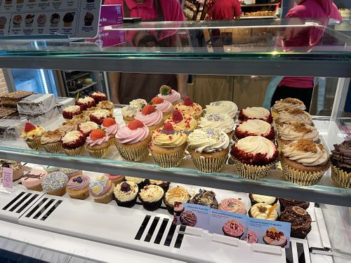 Vegan cupcakes on top row with gold casing  at Lola's Cupcakes - Covent Garden in London