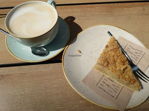 Granola apple pie (Apfelkuchen) and cappuccino with oat milk at Dean & David - Weliosplatz in Wels