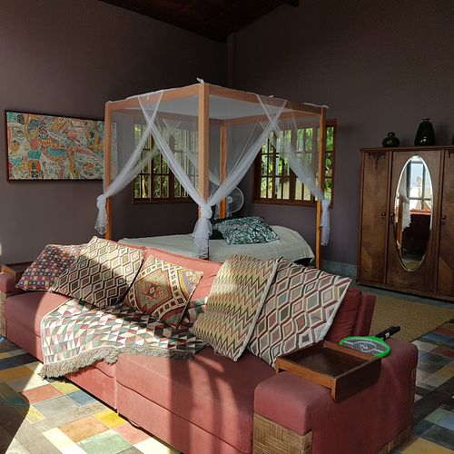 The big luxury honeymoon loft comes with a queen size bed w/quality mattress and extra topper, luxury linen, canopy and mosquito net, windows on all sides and six meter high ceilin at Soulrebel Rio in Rio De Janeiro