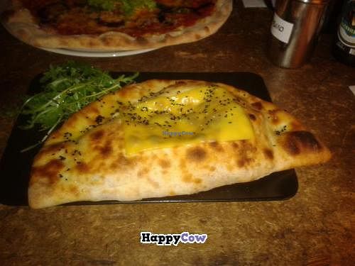 Calzone with cheese on top at Sfizy Veg in Berlin