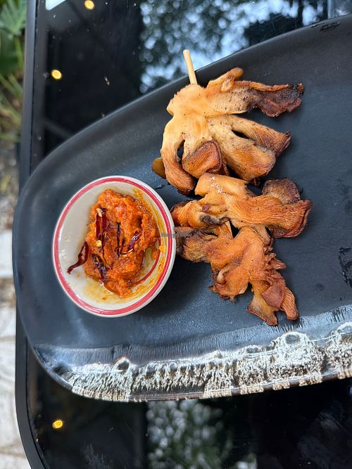 Mushroom skewers (minus one because someone was hungry!🤤 )  at Earth House Restaurant And Wine Bar in Bangkok