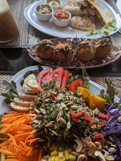 Back to front: iced oat latte, vegan quesadilla, fried (cashew) "cheese" balls, rainbow salad. at Poke Bowl in Koh Chang