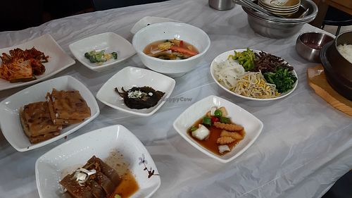 Two types of tofu, kimchi, pickled sesame leaf, vegetables for mixing into bibimbap at Chilgapsan - 칠갑산맛집 in Cheongyang