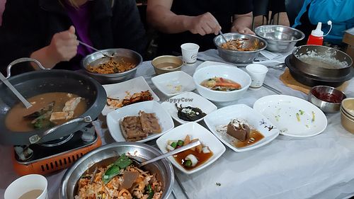 Side dishes, rice and Cheonggukjang jjigae (fermented soybean soup), all part of the bibimbap set at Chilgapsan - 칠갑산맛집 in Cheongyang