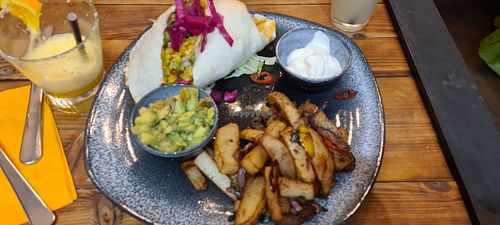Vegan burrito with vegan garlic mayo, salt and peppa chips and guacamole. at Number 11 in Whitehaven