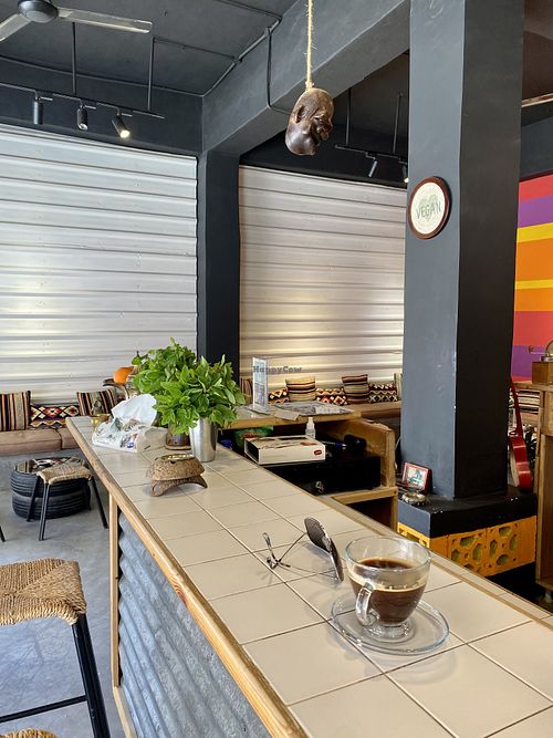 Sitting at the bar  at Frankfurter Supermarket & Cafe in Madaba