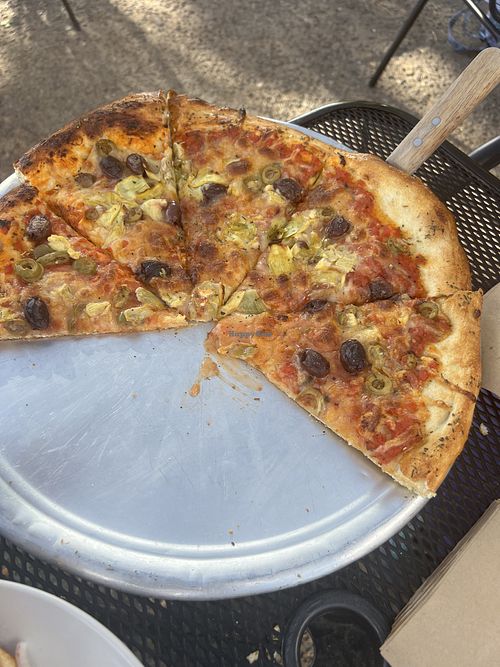 Vegan pizza with olives and artichoke hearts and vegan cheese. Kids were hungry and grabbed slices before I could take a picture.   at Escalante Outfitters in Escalante