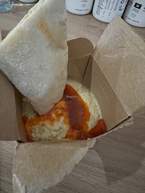 Houmous and pitta bread with a spicy sauce at Nando's in Borehamwood