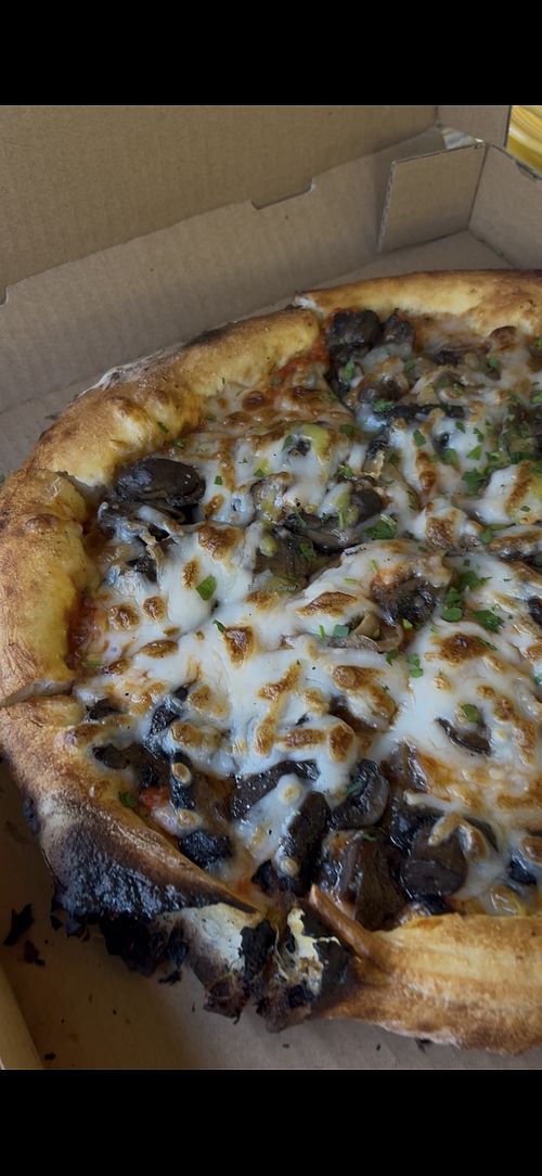 The mushroom pizza was sooo good but did have a burnt crust on one side   at Il Fuoco Pizza in Sonoma