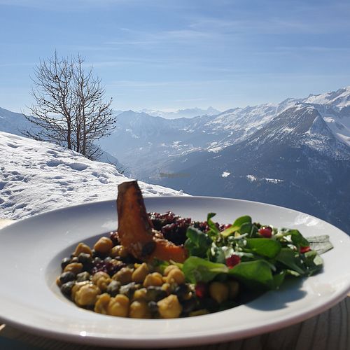 Buddha bowl with a view from the edge of the terrace at Rifugio Campo Base in Ayas