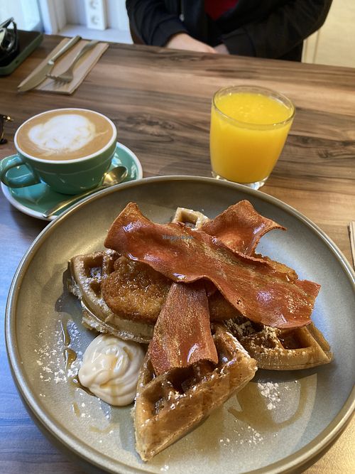 Chickn facon maple syrup waffles, fresh orange juice and a flat white with soya  at Malila Coffee in Valencia